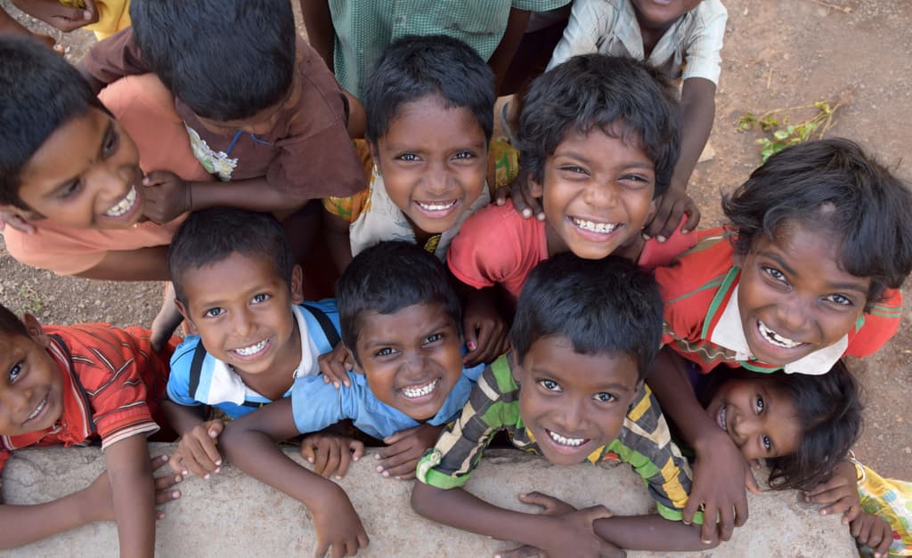 Children smiling together at a community program in India