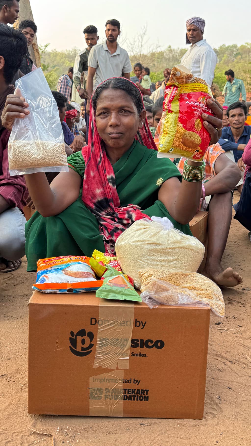 A mother receiving relief ration kit