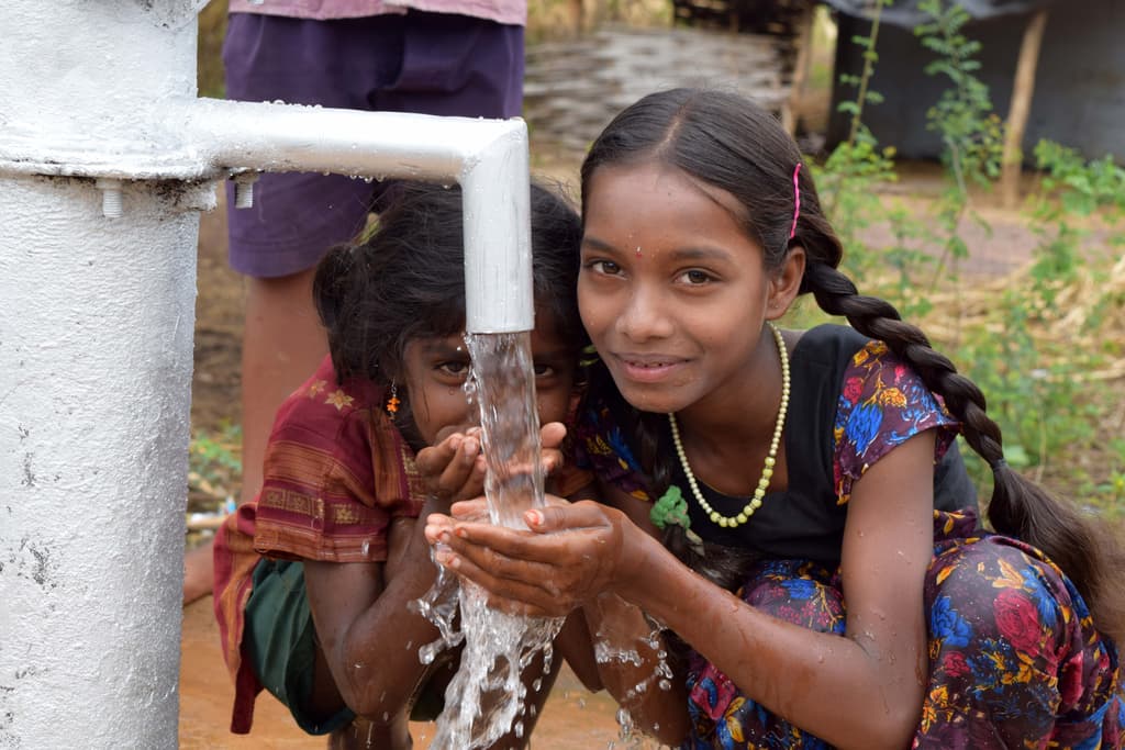 Clean water pouring from a hand pump