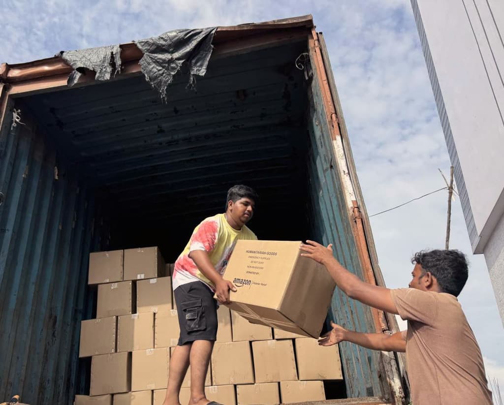 Hands holding a donation box during a relief effort